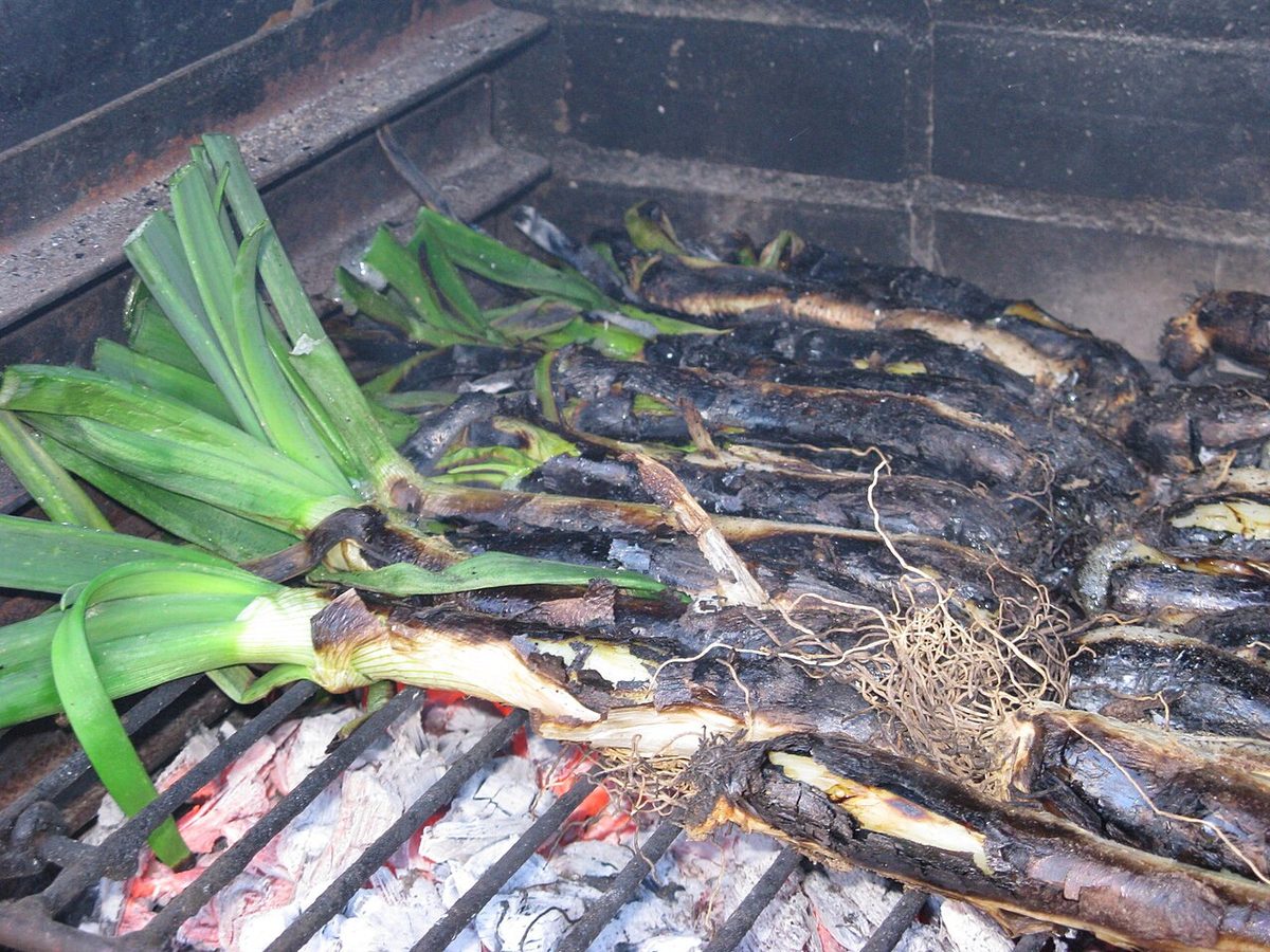 Calcots, the charred sweet spring onions of a Catalan calcotada, served with romesco sauce