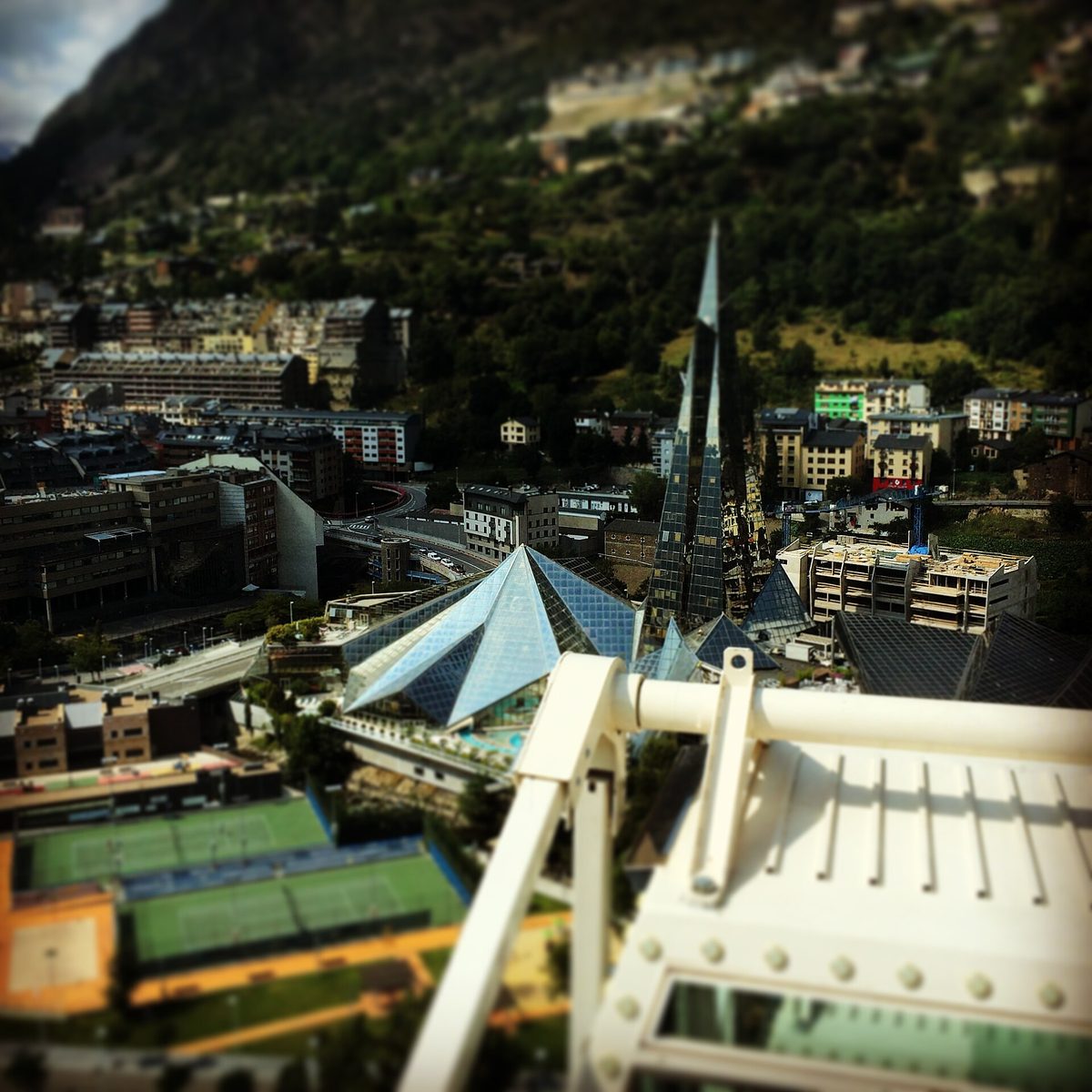 The spa's glass pyramids and 80-metre spire seen from above the Escaldes rooftops