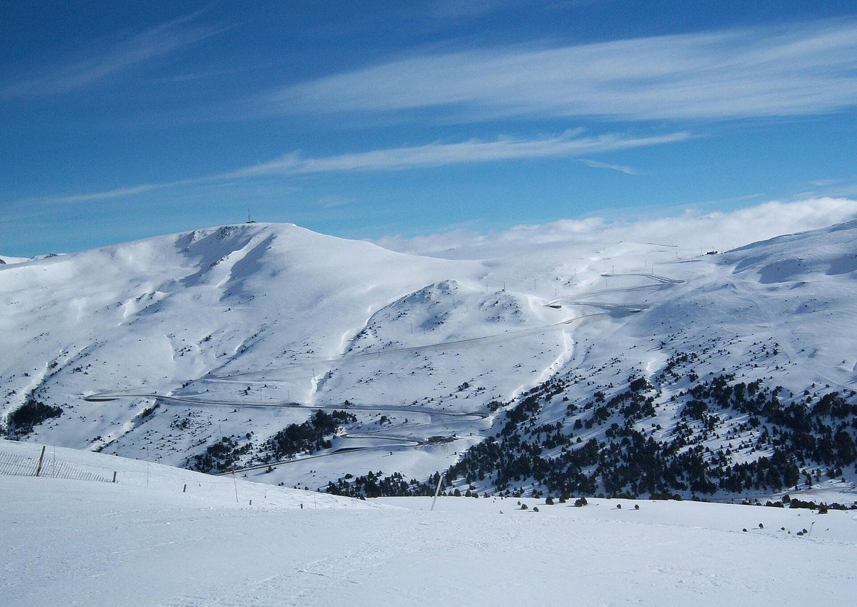 A road winding through the snowy mountains near the Port d'Envalira in Andorra