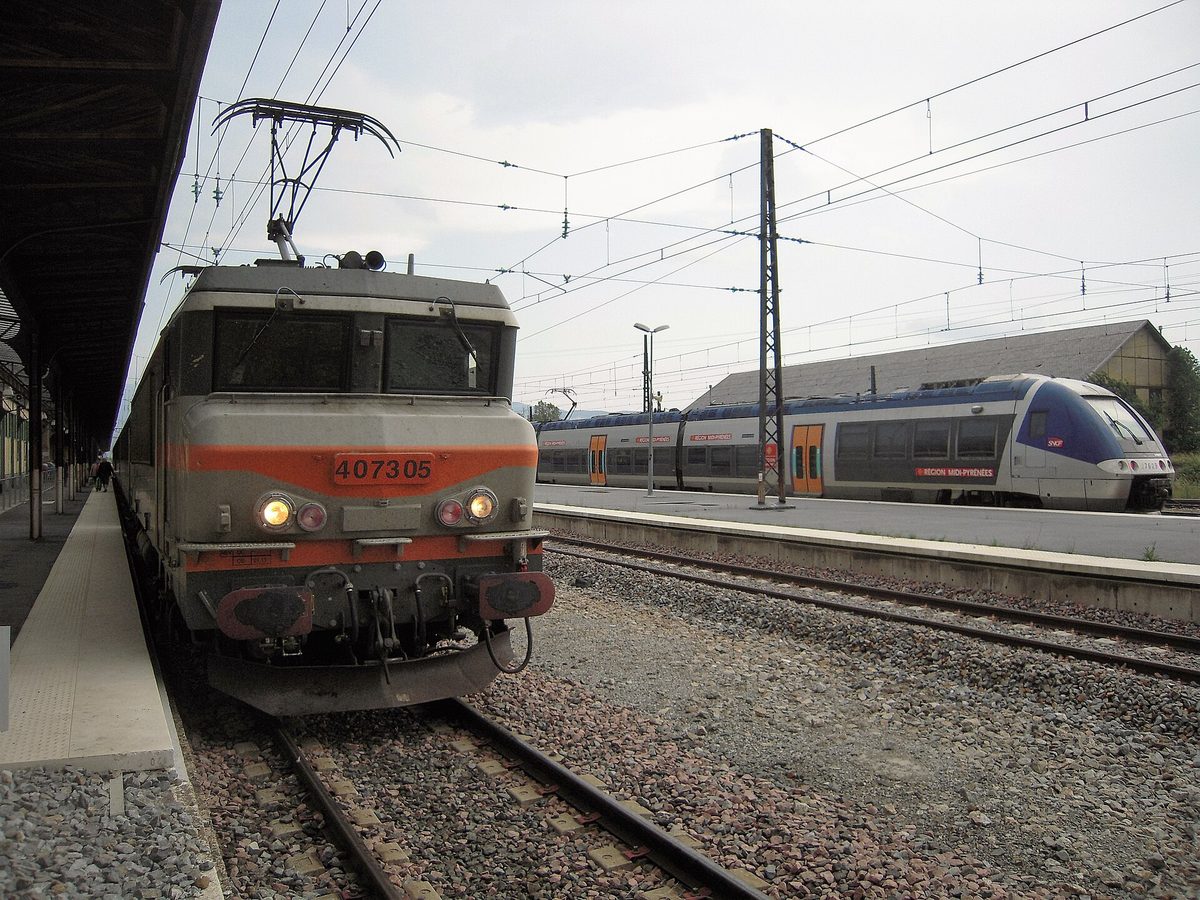 An SNCF train at a Pyrenean station, evoking the celebrated night-sleeper approach towards Andorra