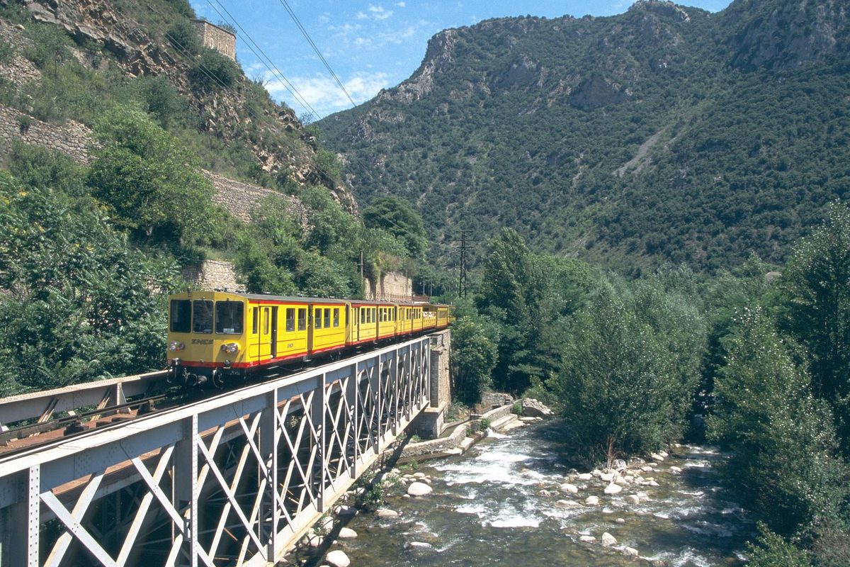 The Petit Train Jaune crossing a gorge, part of the scenic Pyrenean rail network near Andorra